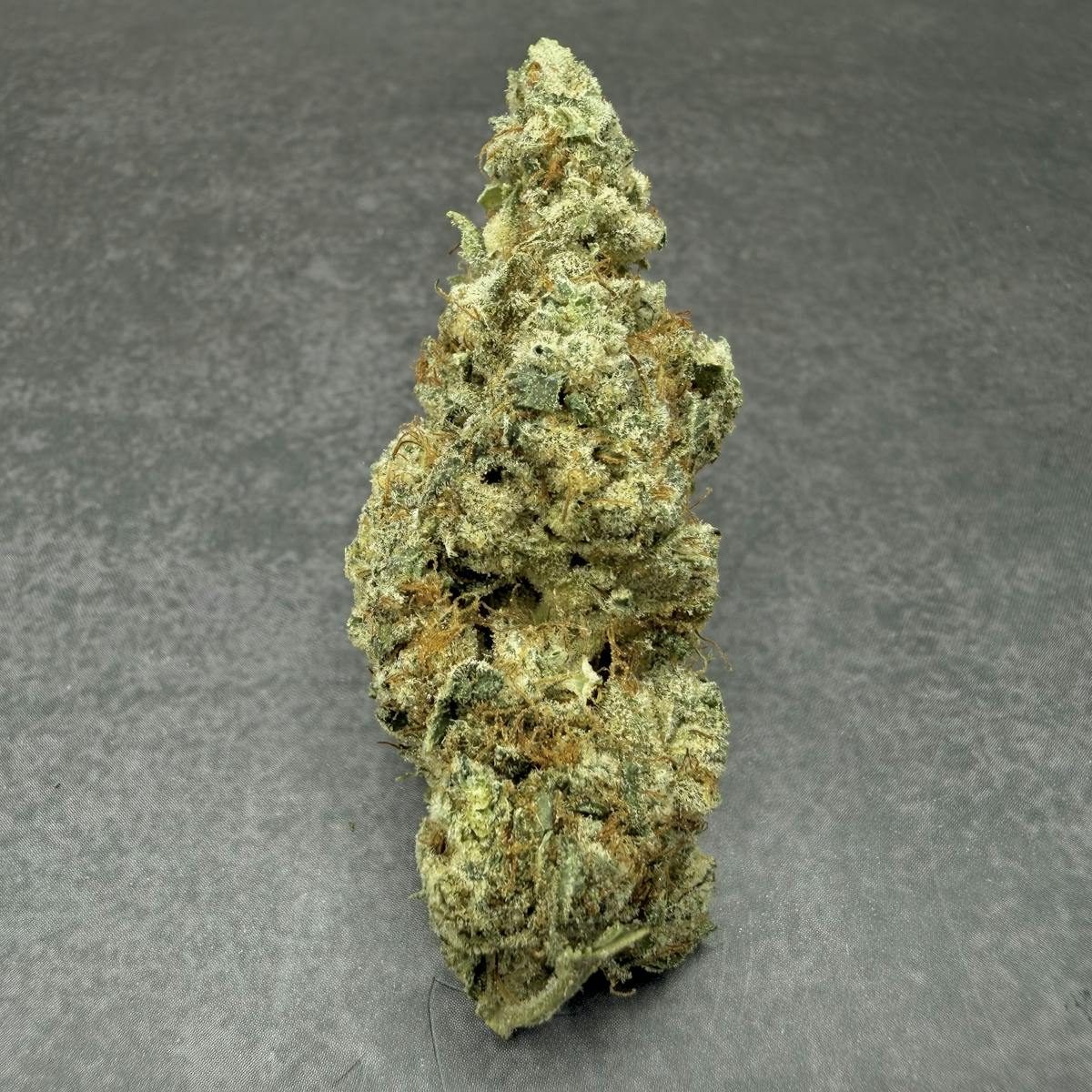 A hand-trimmed cannabis flower on the Strawberry Fields shelf